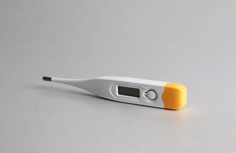 white and yellow thermometer on white surface